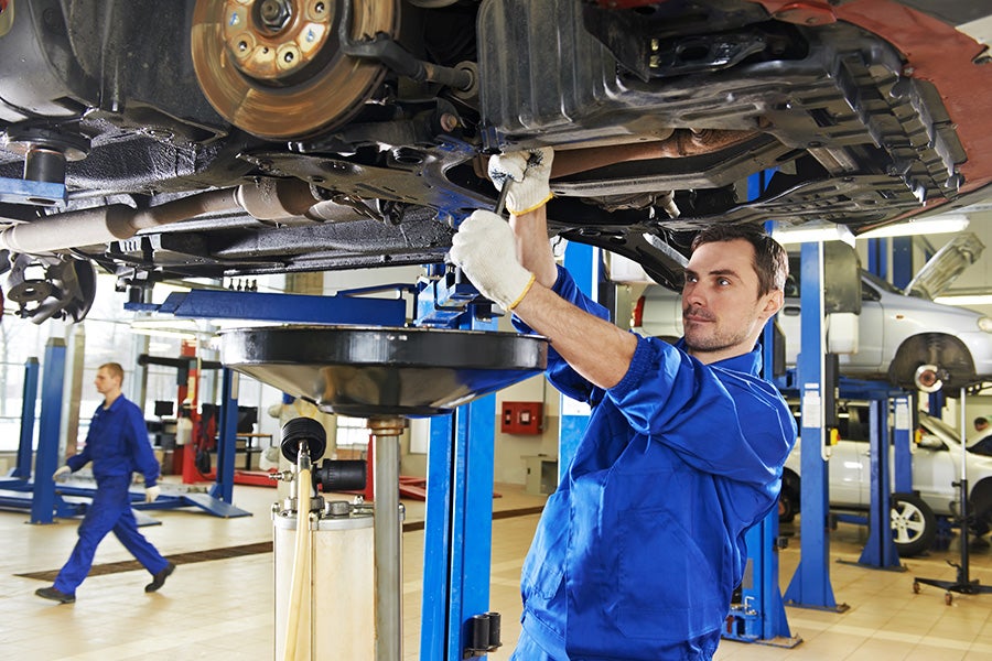 mechanic changing oil at the Criswell GMC Gaithersburg dealership